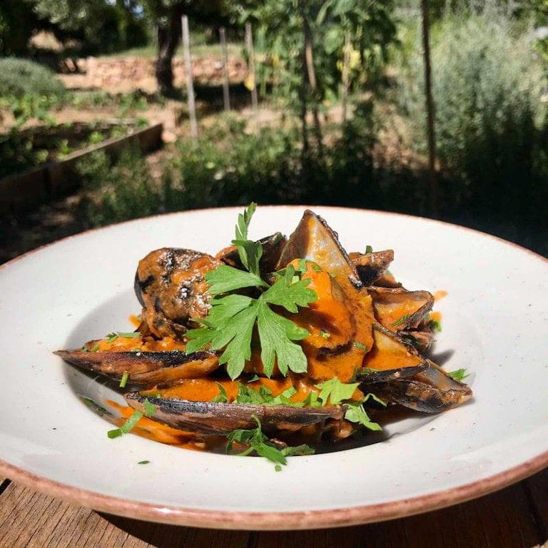 plate with cooked eggplants and fresh parsley from 'The Orchard in Vari' restaurant